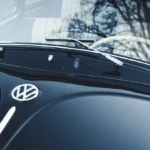 Car windshield with hard water spots being inspected in daylight