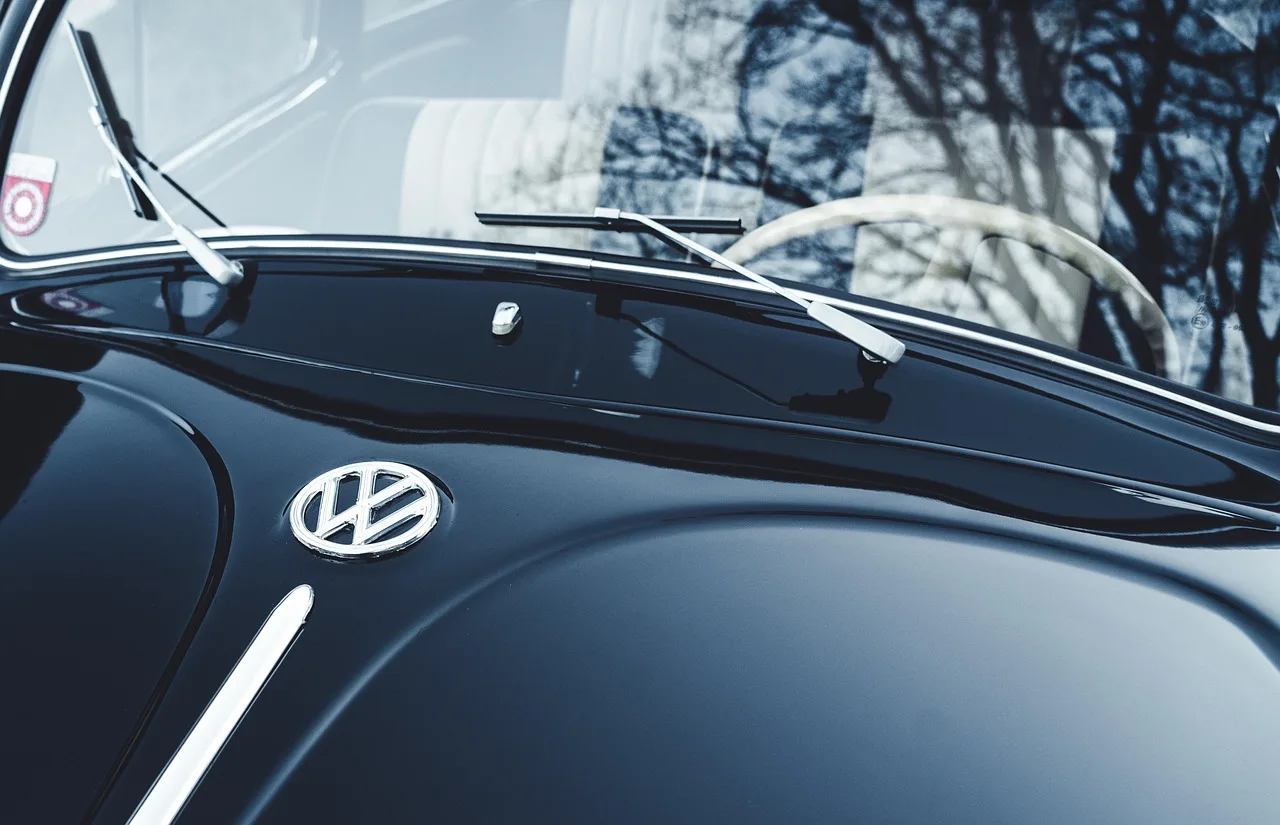 Car windshield with hard water spots being inspected in daylight