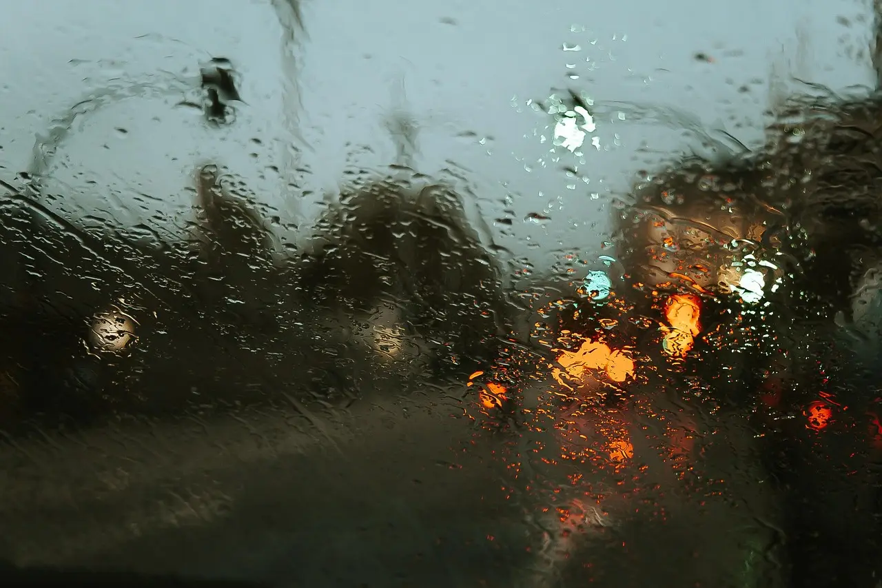 Faint film on the inside of a car windshield with dashboard and vents visible